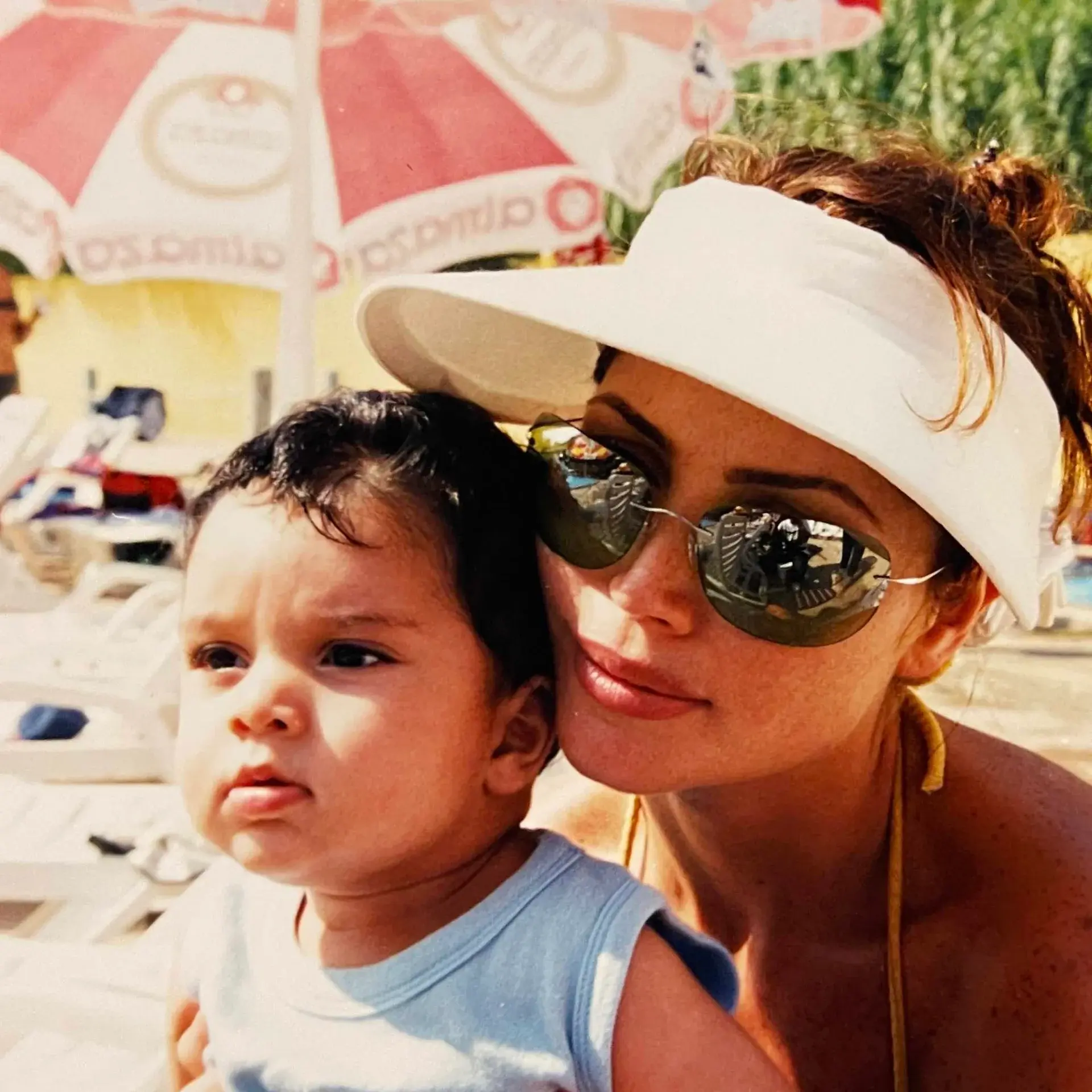 Jihan Alama holding her son Louai as a child, in the sun