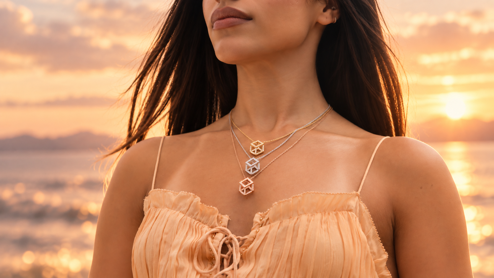 Three Cube Mirage Icon pavé necklaces in yellow, white and rose gold worn at sunset